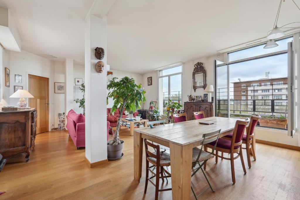 a dining room and living room with a table and chairs at Charming apt for 5 people in Paris by Weekome in Paris