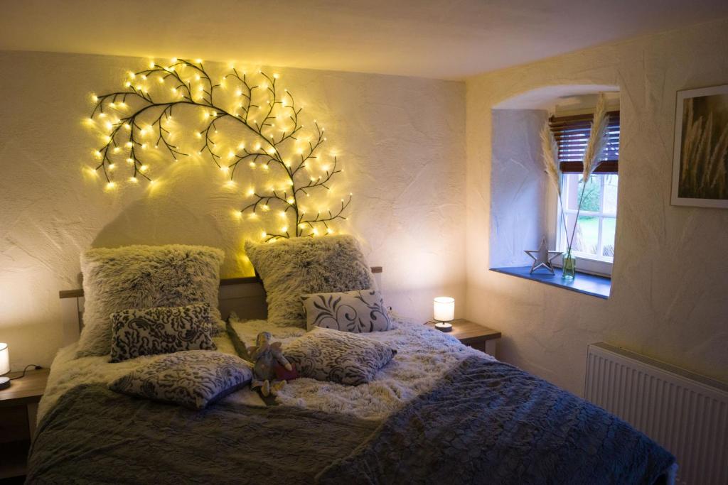 a bedroom with a large bed with lights on it at Ferienwohnung Zum Jehöschnis in Gerolstein