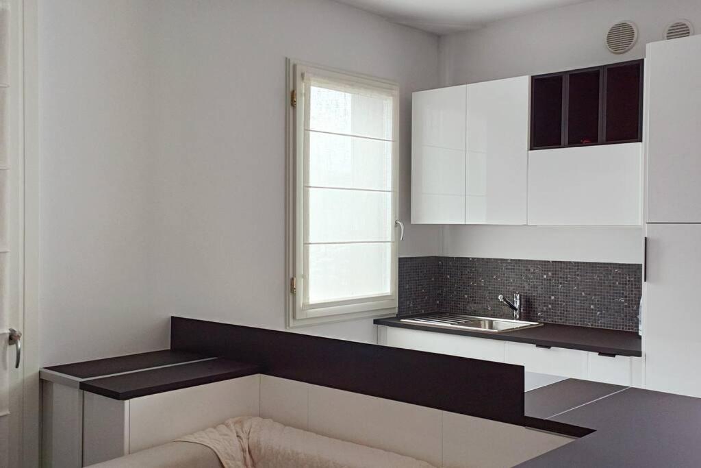 a kitchen with white cabinets and a sink at Boutique apartment Alla Dolce Vita in Vicenza