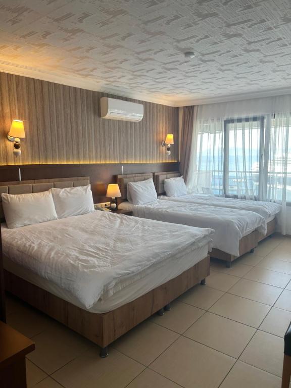 Postel nebo postele na pokoji v ubytování Hotel Stella