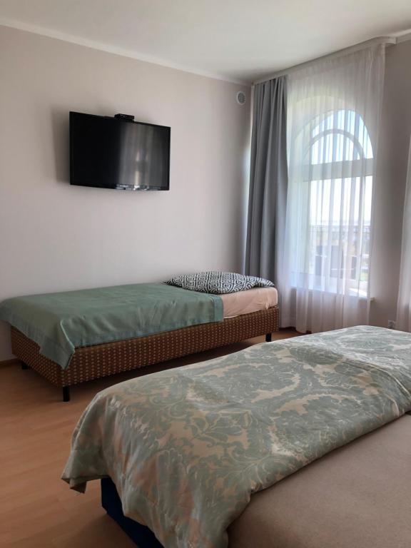 Postel nebo postele na pokoji v ubytování Willa Wicko - Międzyzdroje - apartamenty z aneksem - widok na Zalew Szczeciński