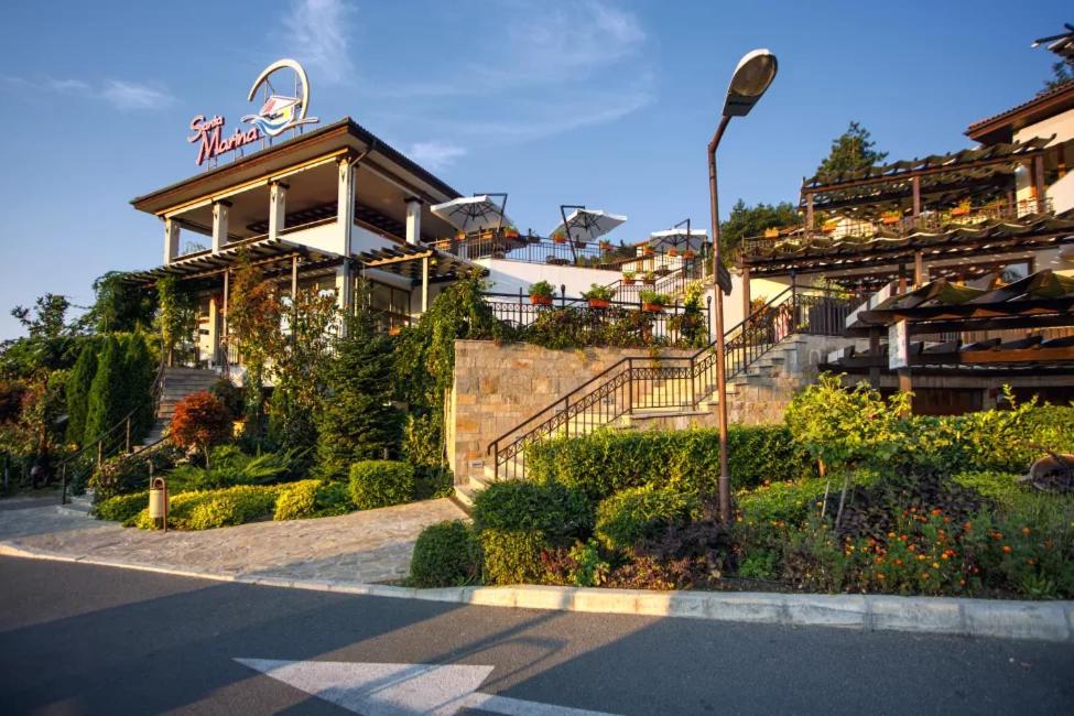 a building with a sign on the side of a street at Santa Marina Holiday Village Studio Iskra in Sozopol