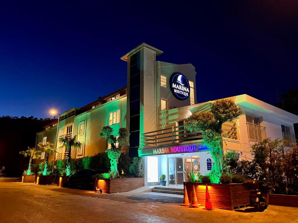 a building with a sign on the side of it at Marina Boutique Hotel in Fethiye