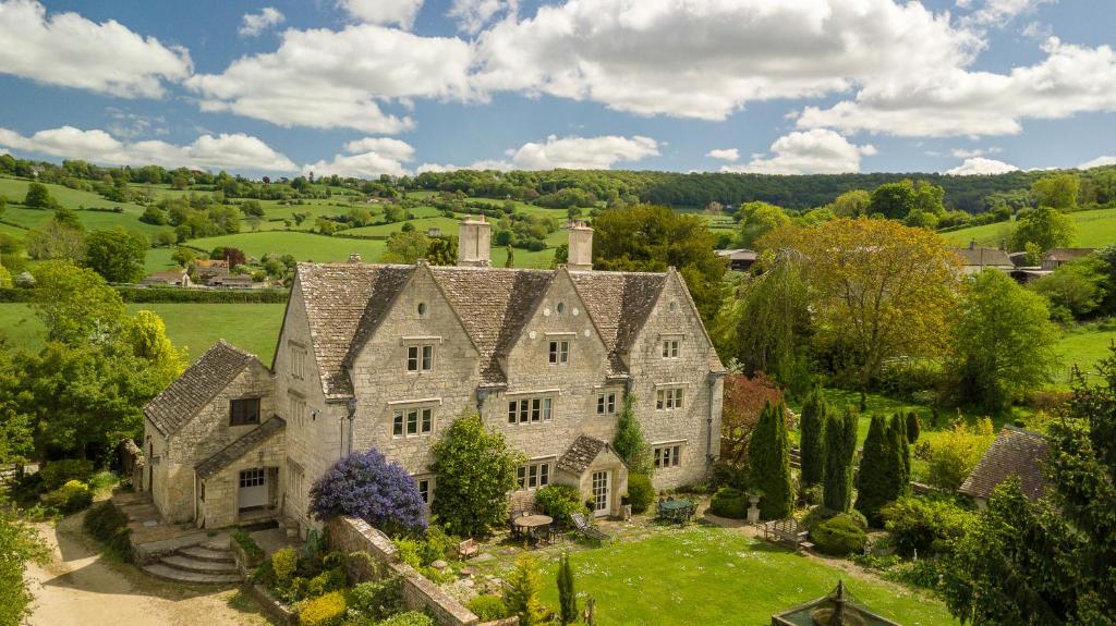 an aerial view of a large stone house with a garden at Hayes Farm - 8 Houses in Gloucester