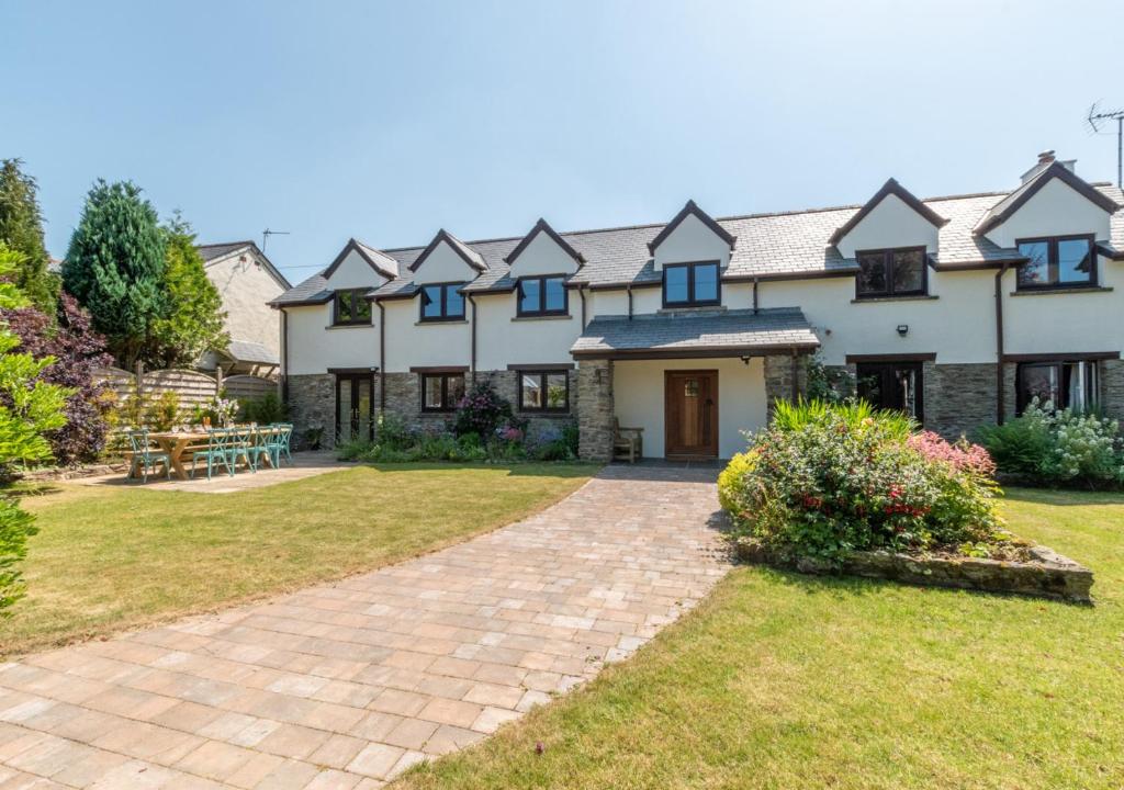 a large white house with a brick driveway at Barton Farm in West Down