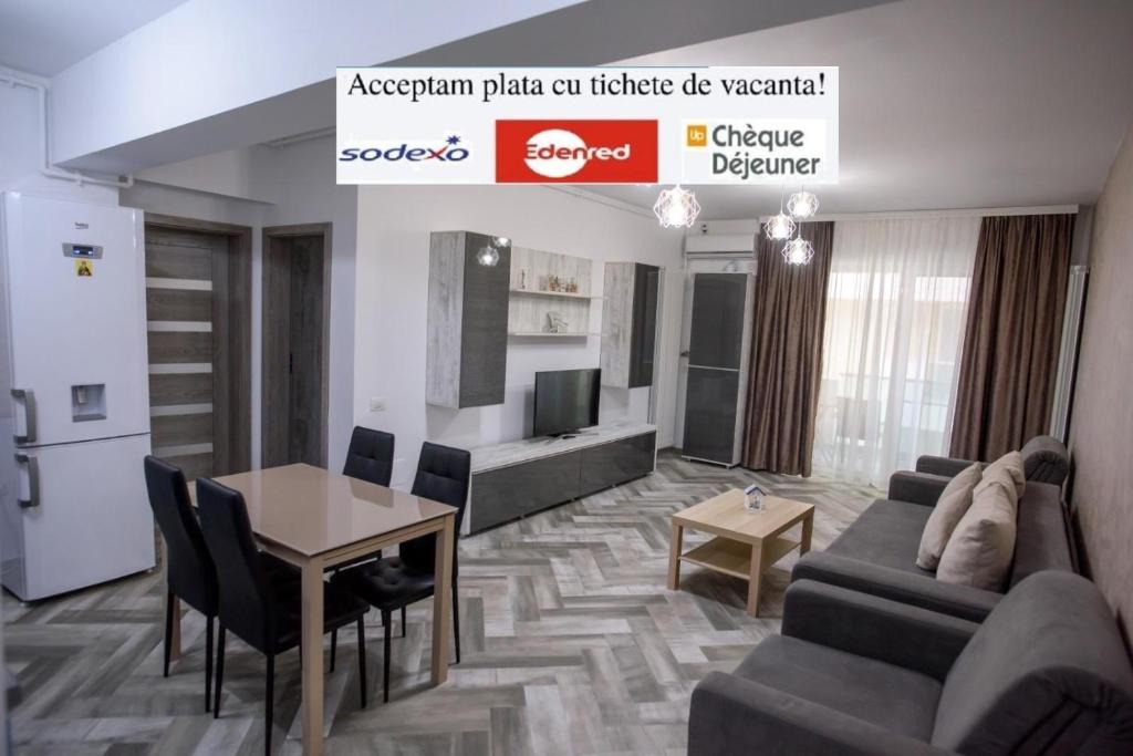 ein Wohnzimmer mit einem Sofa und einem Tisch in der Unterkunft Moonlight Apartments in Mamaia