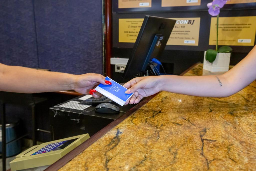 a person holding a lego toy in front of a counter at Rio Aeroporto Hotel Galeão in Rio de Janeiro