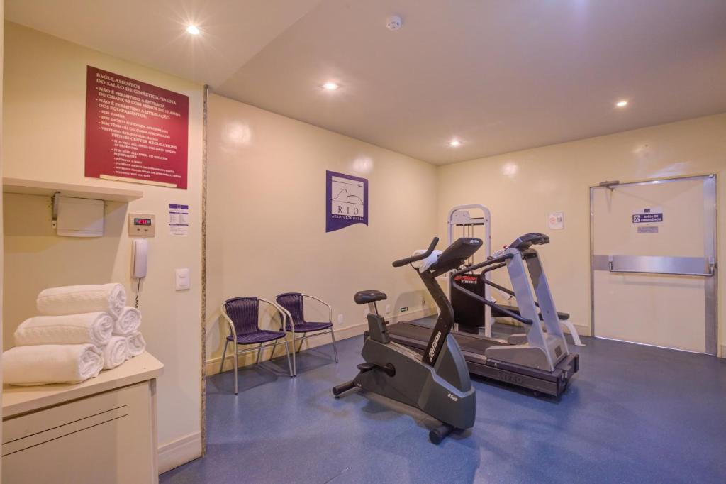 a gym with two tread machines in a room at Rio Aeroporto Hotel Galeão in Rio de Janeiro