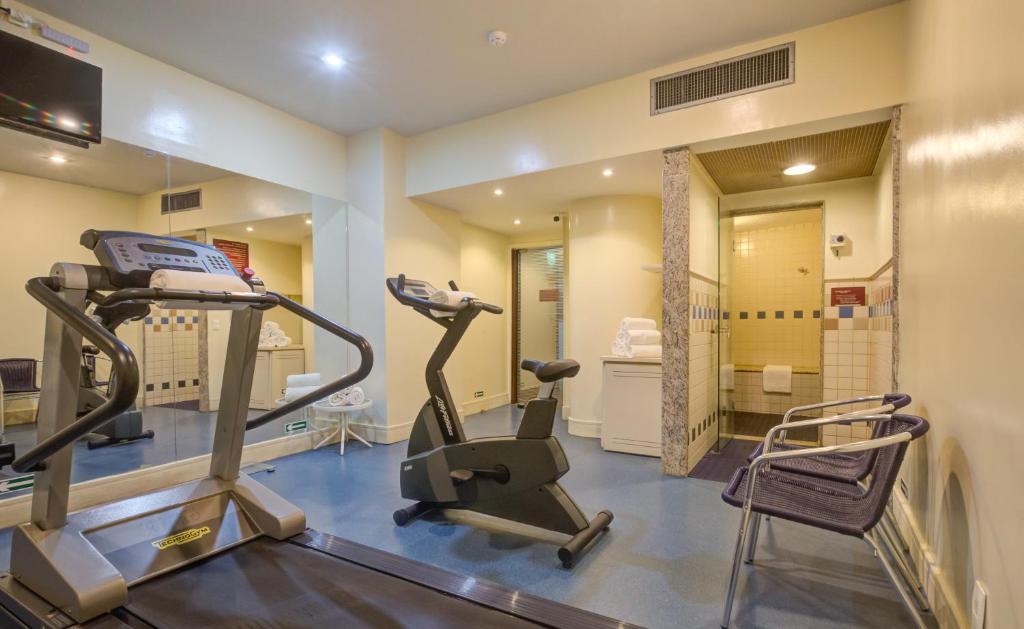 a gym with two tread machines and a mirror at Rio Aeroporto Hotel Galeão in Rio de Janeiro