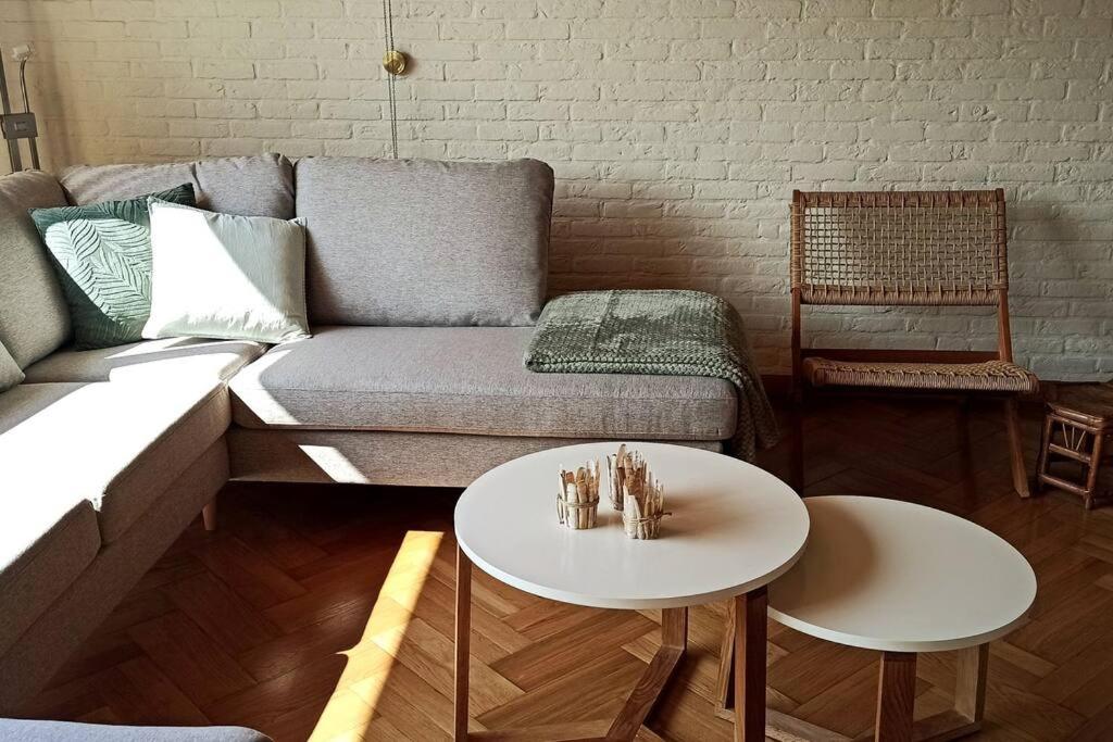 a living room with a couch and a table at Mozaïkhuis in De Haan