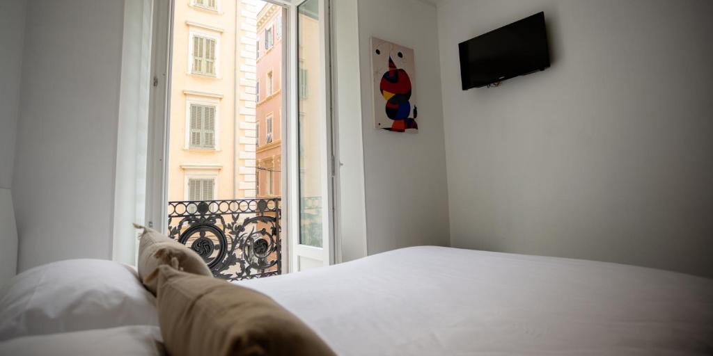 Postel nebo postele na pokoji v ubytování Hôtel Napoléon