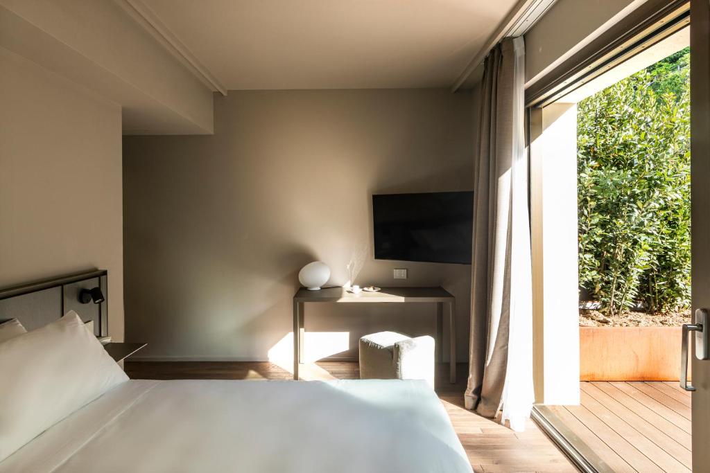 Postel nebo postele na pokoji v ubytování Hotel Promessi Sposi