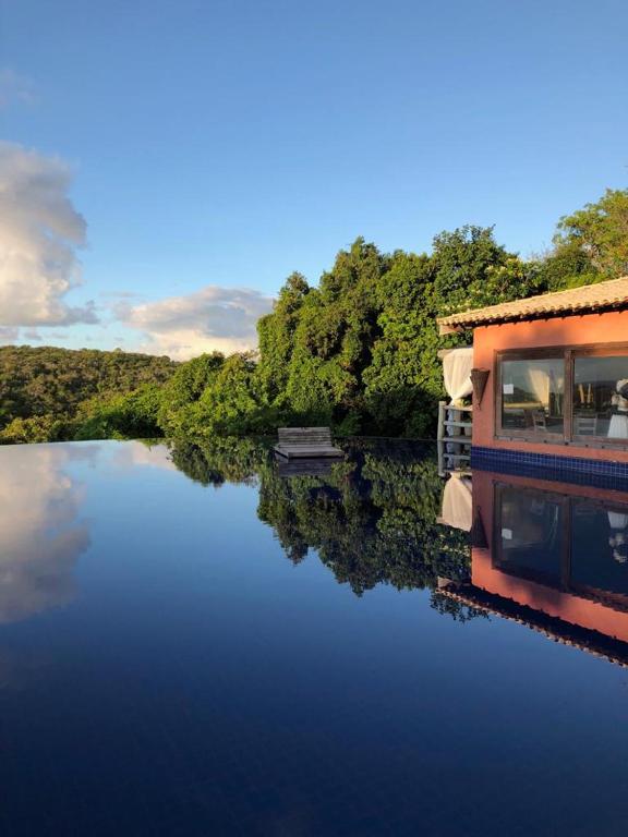 a boat on a river with trees in the background at Studio Luxo Ecológico. in Maceió