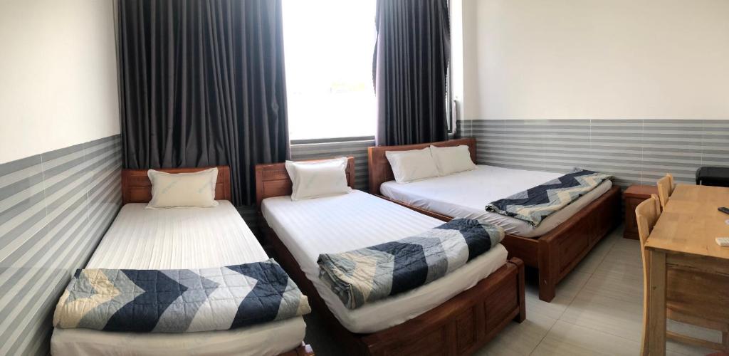 Postel nebo postele na pokoji v ubytování Hotel Sen Việt Bạc Liêu