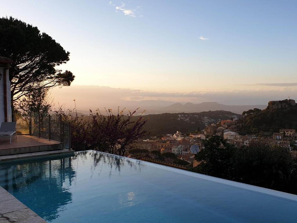 a swimming pool with a view of a city at Ibiza in Begur