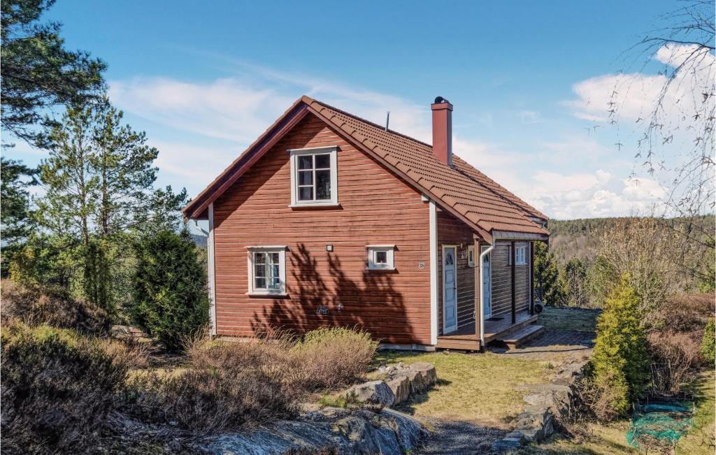 a small house in the middle of a field at Amazing Home In Risr With Wifi in Risør