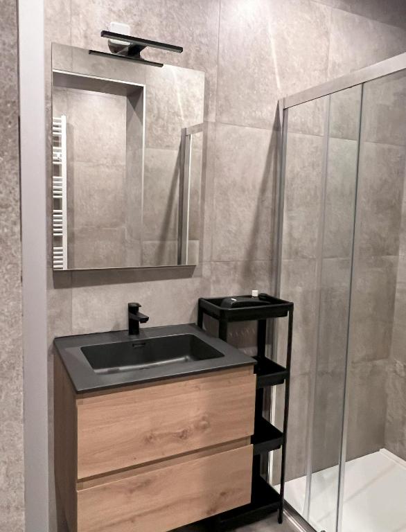 a bathroom with a sink and a mirror at Le Franchet in Dinant