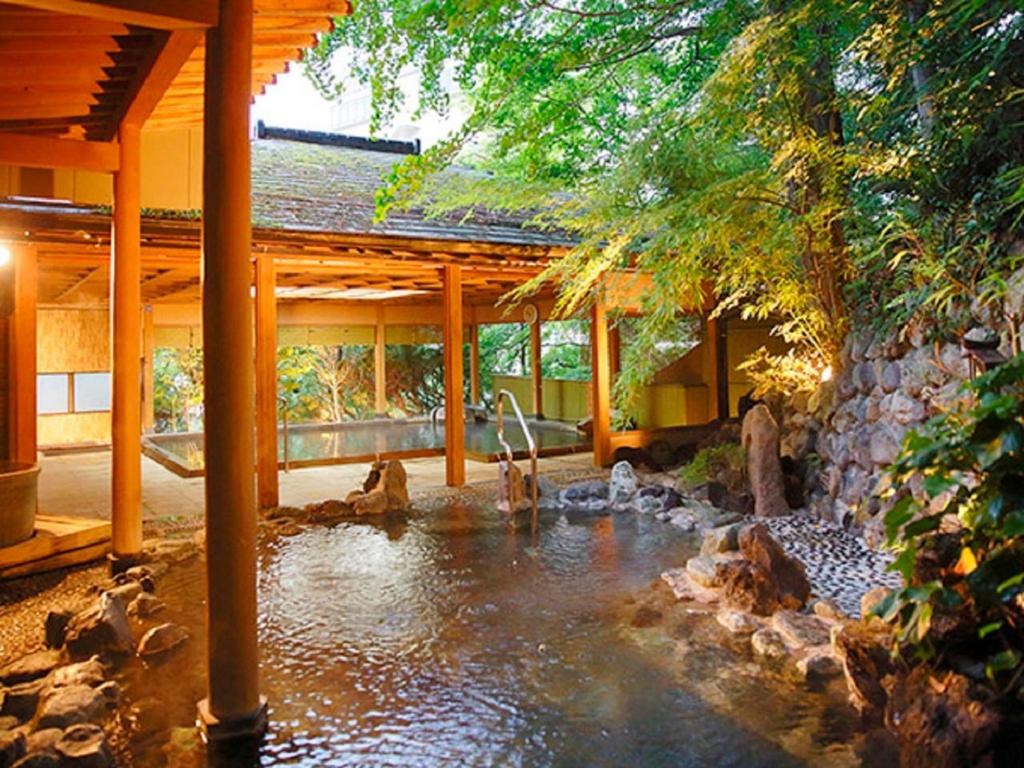 um lago no meio de uma casa com um edifício em LiVEMAX RESORT Kawaji em Nikko