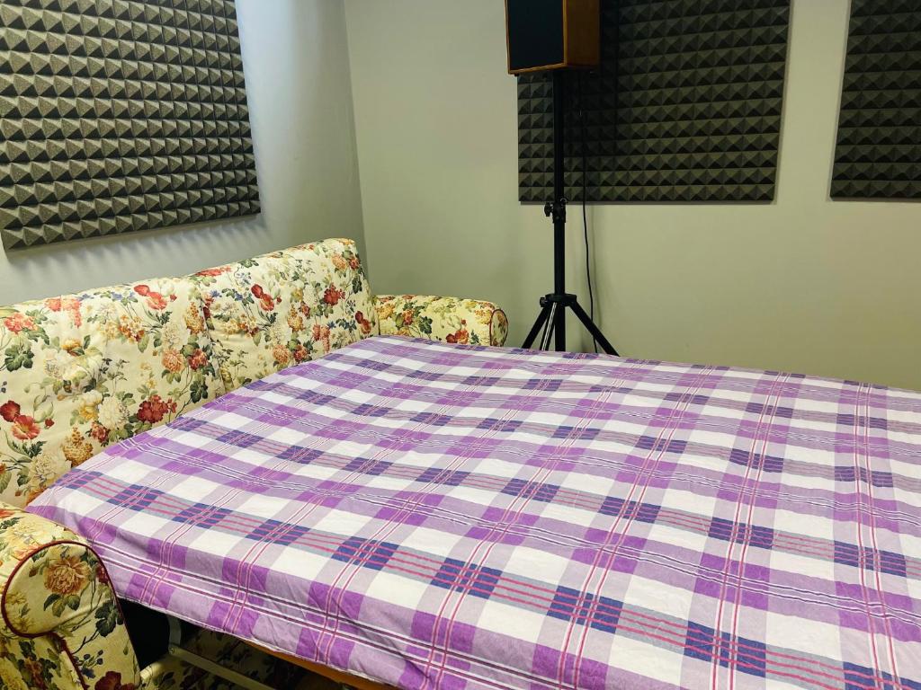 a table and two chairs with a purple and white plaid table cloth at Office Room 