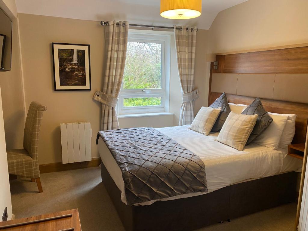 a bedroom with a bed and a window at Garden Rooms Ferry Rd Pitlochry in Pitlochry