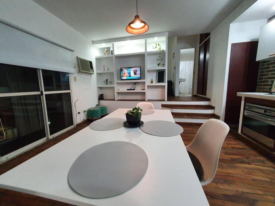a living room with a white table and chairs at Loft5 a solo 2 cuadras de la Costanera!!! in Corrientes
