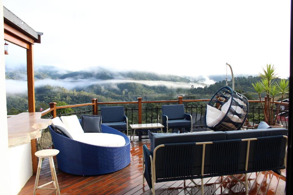 a balcony with chairs and a view of a mountain at Casa Primavera by The Lodges in Campos do Jordão