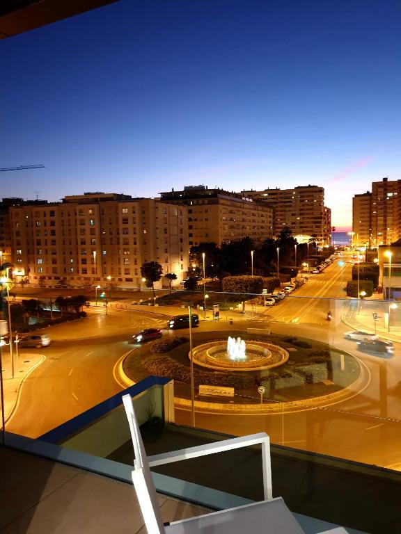 a view of a city at night with a fountain at LHOME CÁDIZ in Cádiz