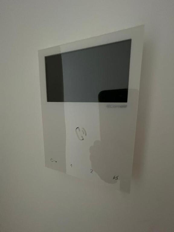 a white bathroom with a mirror on a wall at LHOME CÁDIZ in Cádiz