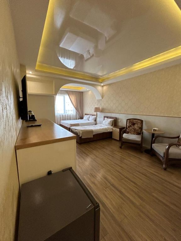 a large living room with a couch and a bed at Aleppo Hotel in Yerevan