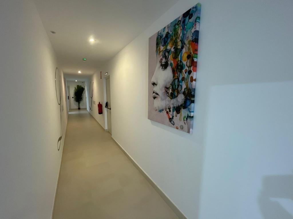 a hallway with a large painting on the wall at LHOME CÁDIZ in Cádiz