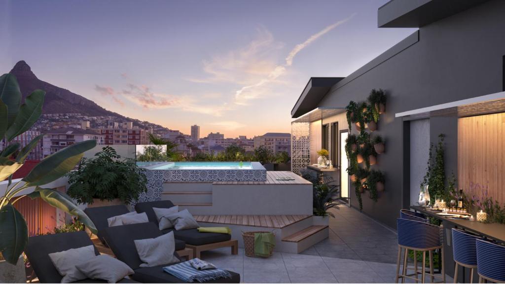 a rooftop patio with a swimming pool on a building at SixOnN Luxury Apartments by Elevate in Cape Town