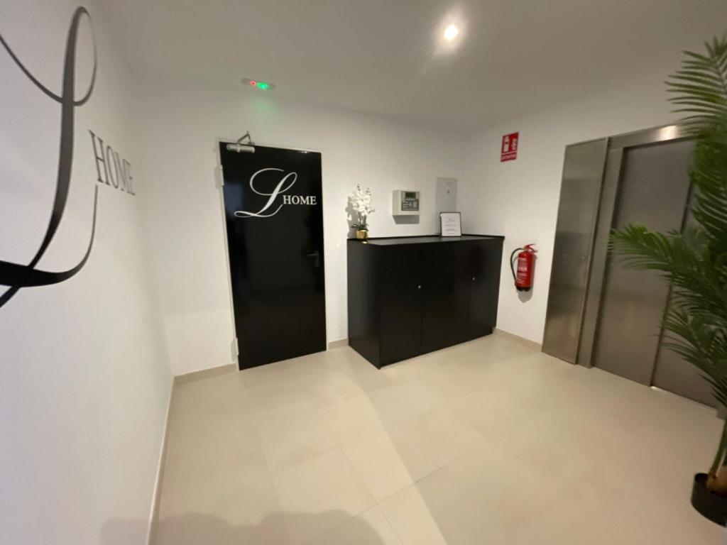 a room with a black and white sign on the wall at LHOME CÁDIZ in Cádiz