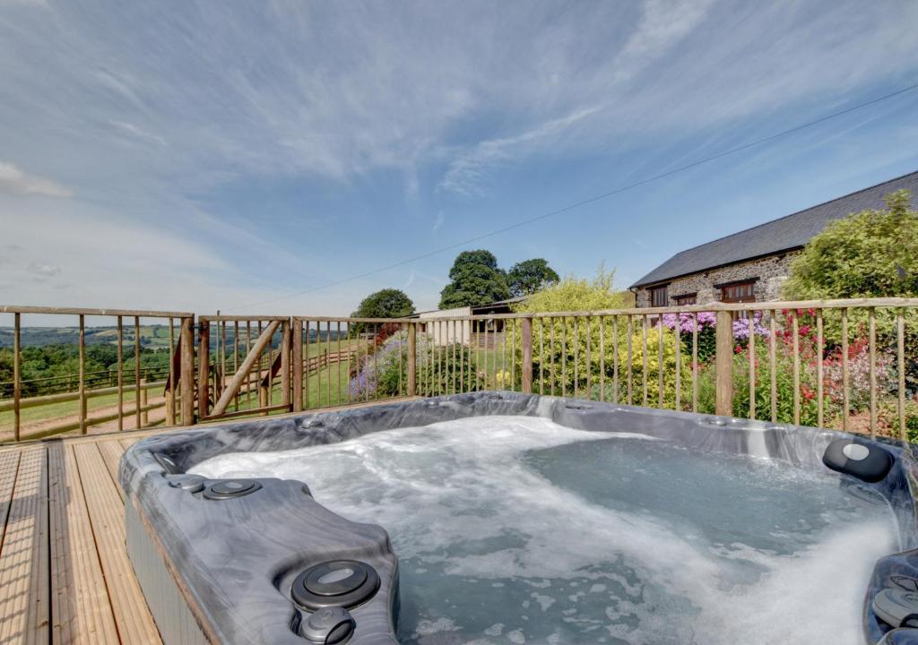 a hot tub on the deck of a house at The Gearing in Bampton