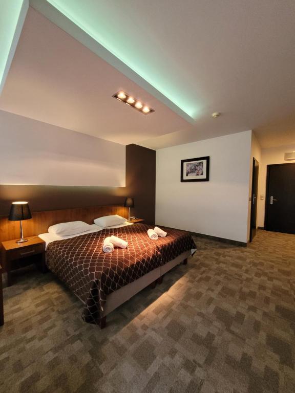 a bedroom with a large bed in a room at Diva Resort in Kołobrzeg