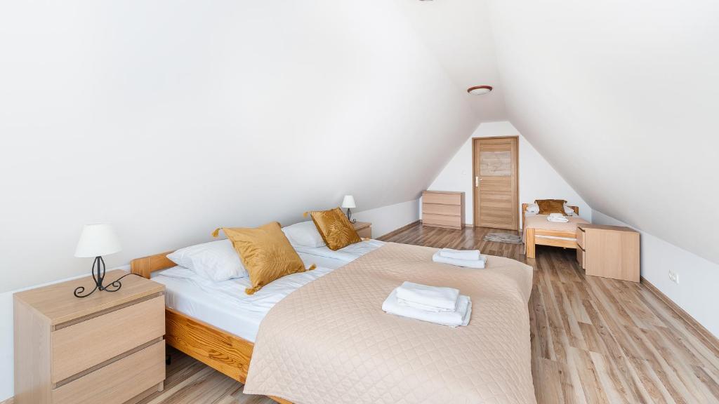 Postel nebo postele na pokoji v ubytování Apartamenty Sun & Snow Pardałówka