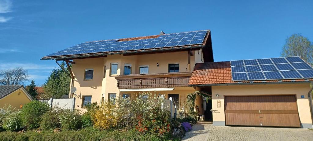 a house with solar panels on the roof at Ferienwohnung “Haus Rita” in Riedlhütte