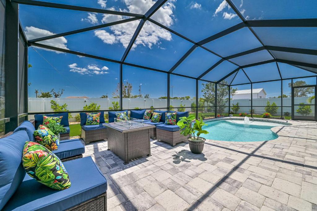 a pavilion with a pool and chairs and a table at VILLA AWESOME! in Cape Coral