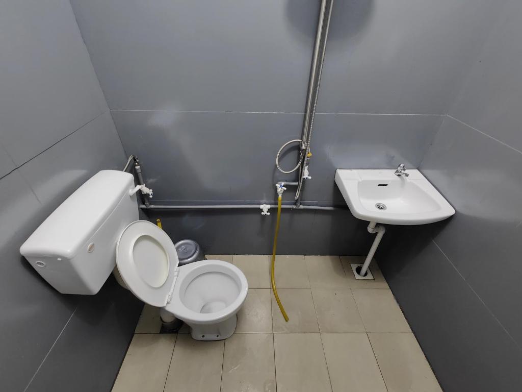a bathroom with a toilet and a sink at TBE Room2stay at Jalan BR3 in Melaka