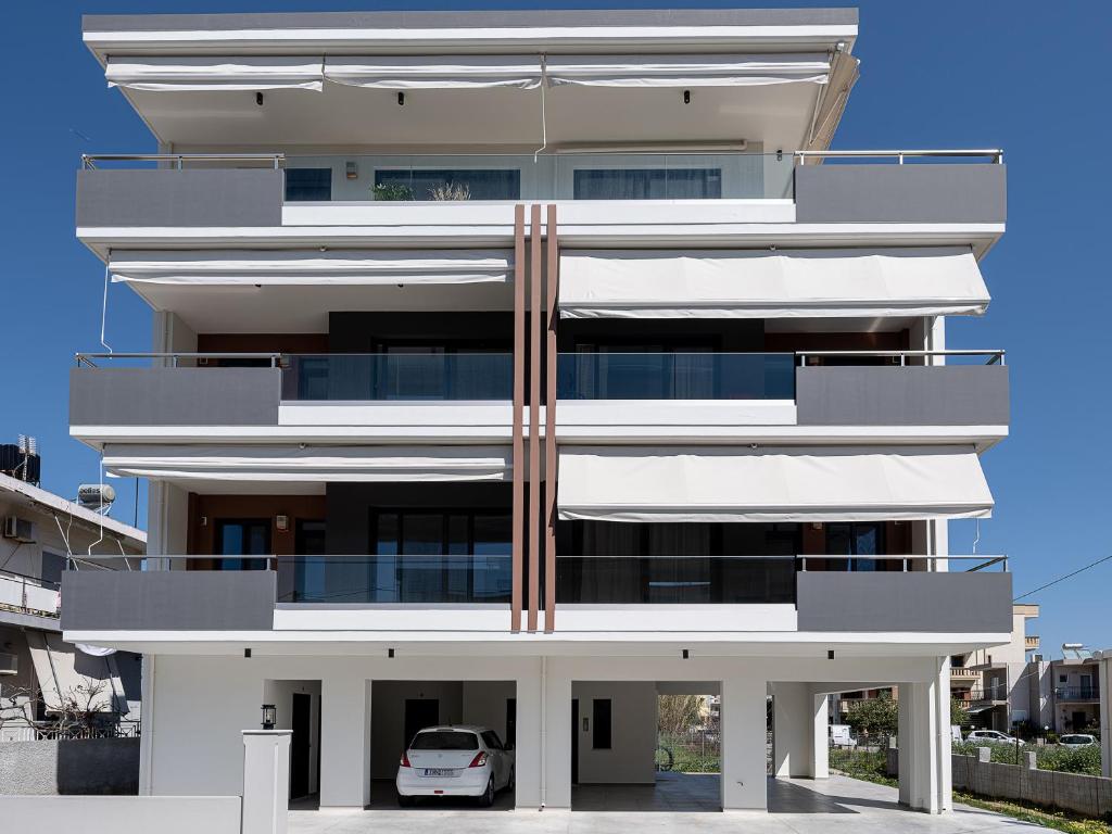 a building with a car parked in front of it at Mossa City Apartments in Chania Town