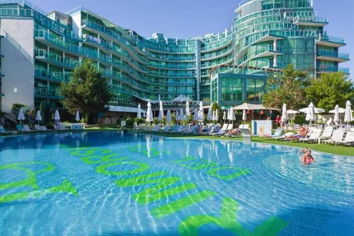 a large swimming pool in front of a large building at Двустаен апартамент в Приморско in Primorsko