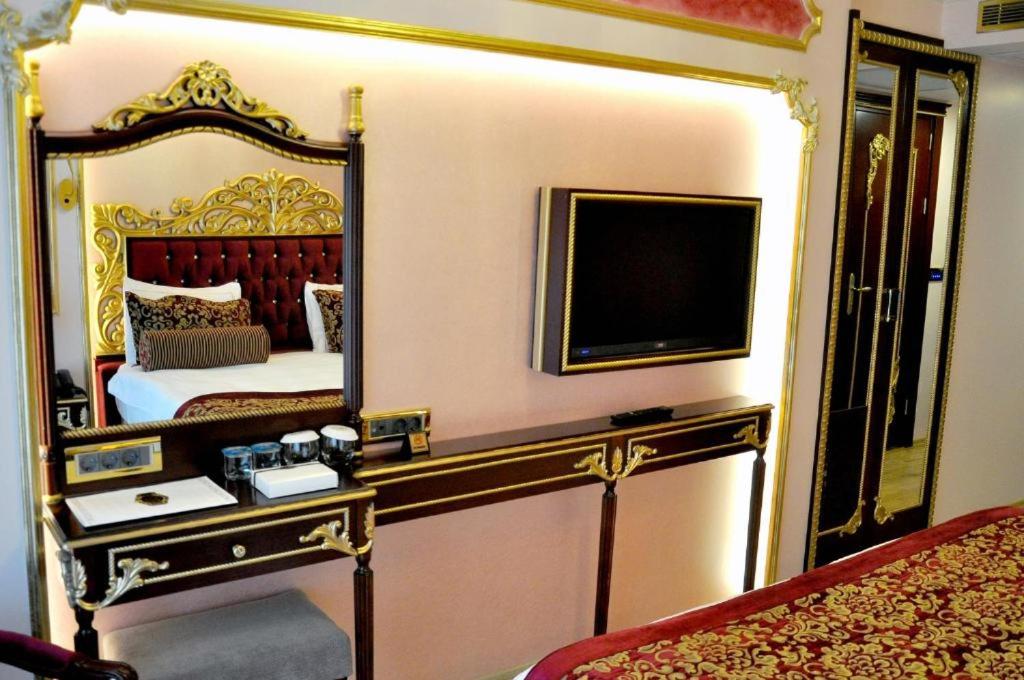 a bedroom with a bed with a large mirror at Golden Marmara Hotel in Istanbul