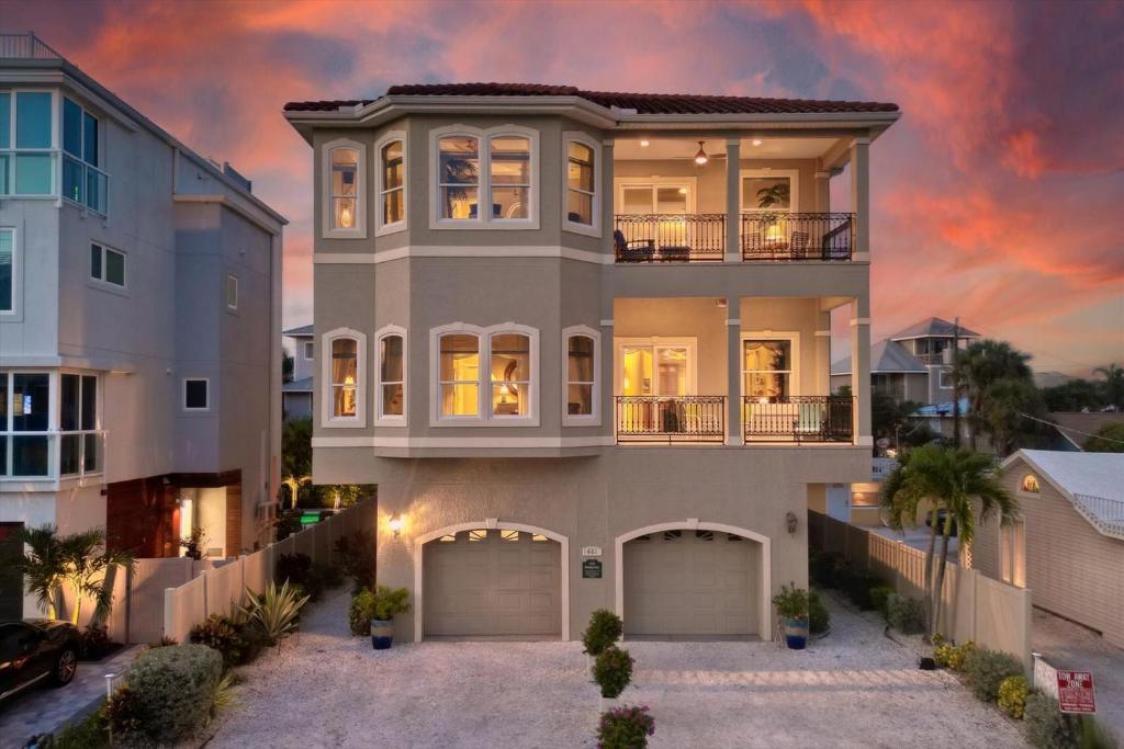 a large house with a sunset in the background at Ocean Vue in Siesta Key