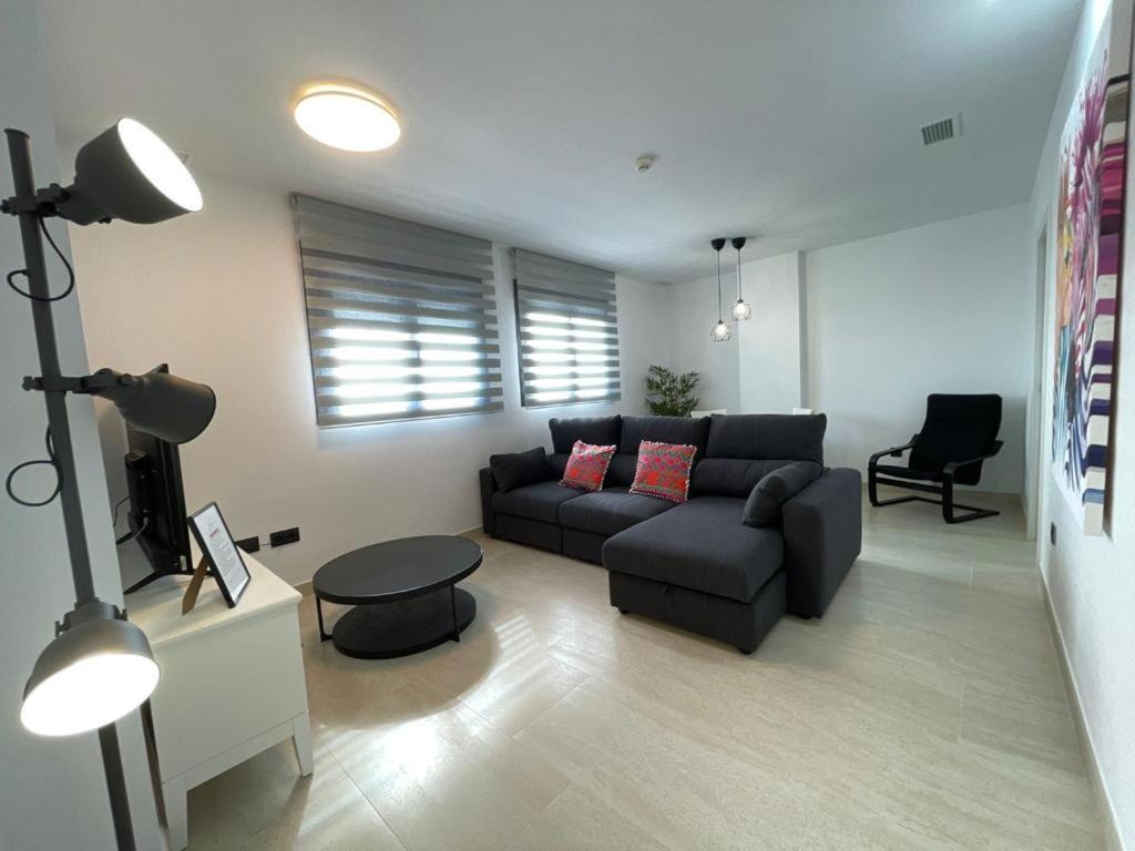 a living room with a couch and a table at LHOME CÁDIZ in Cádiz