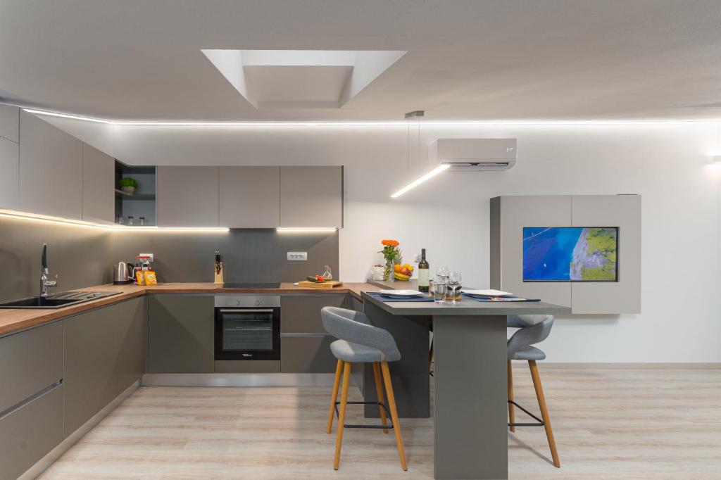 a kitchen with a table and two stools at Apartment Ena Arena Pula in Pula