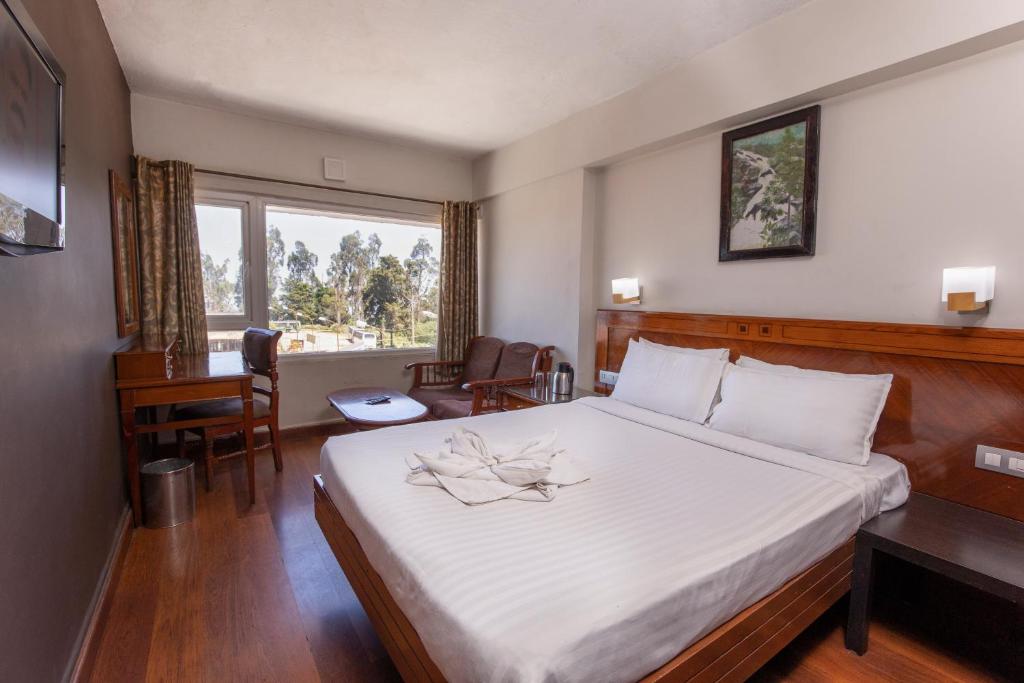 Postel nebo postele na pokoji v ubytování Hotel Jc Grand
