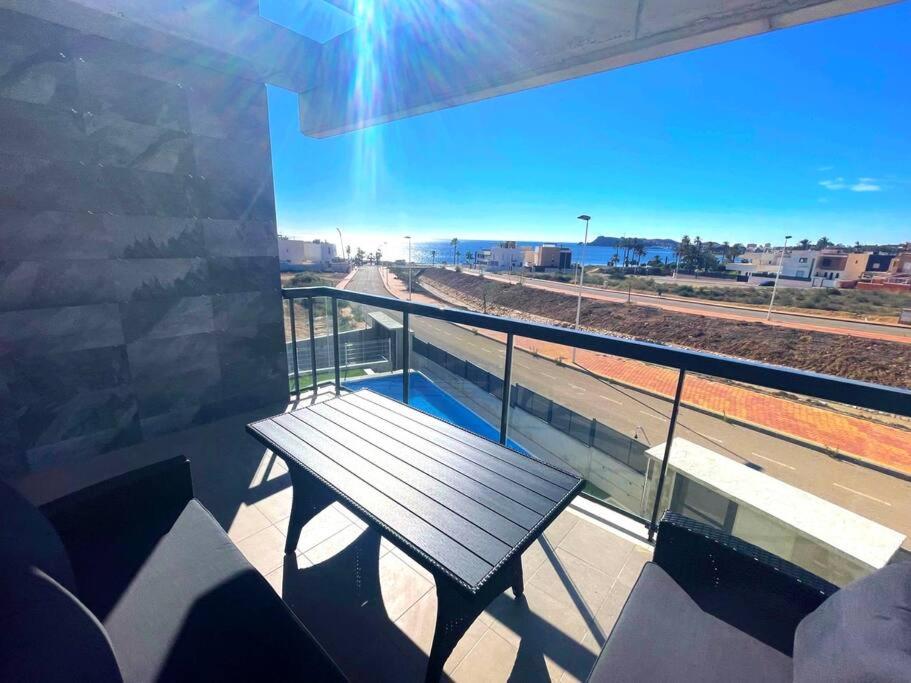 a balcony with a bench and a view of a train track at New built 3-bed penthouse with pool, Mar de Plata in Mazarrón