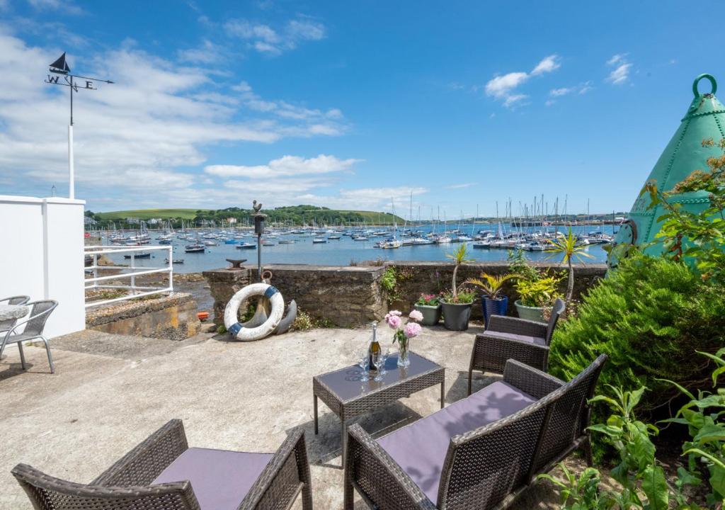 a patio with a table and chairs and a marina at The Anchorage in Falmouth