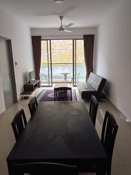 a dining room with a black table and chairs at Cold house in Cameron Highlands