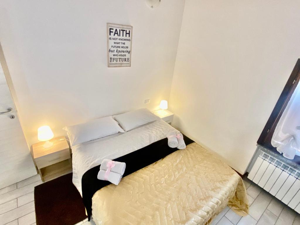 a small bedroom with a bed and a small stool at In Love 01 in Montichiari
