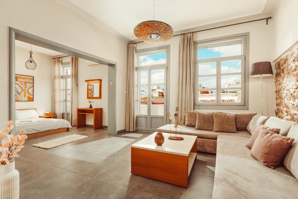 een woonkamer met een bank en een bed bij Suitas in Athene